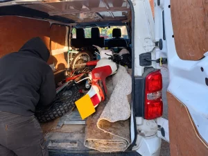 Motorcycle transported on its side in the back of a general purpose van